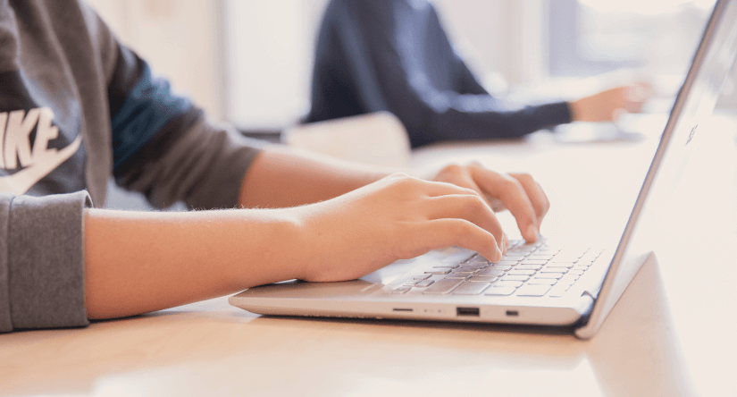 Student typing on computer